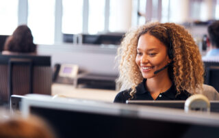 Customer service representative wearing a headset while handling customer conversations in a contact center